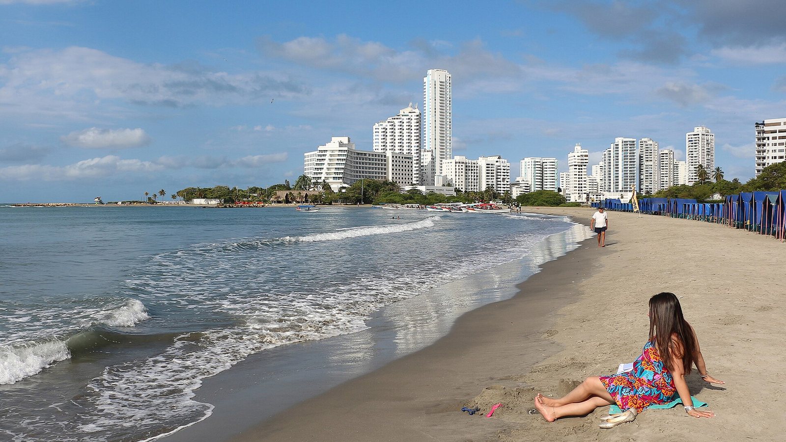 Playa de Bocagrande en Cartagena con edificios altos al fondo y un espigón de roca a la izquierda
